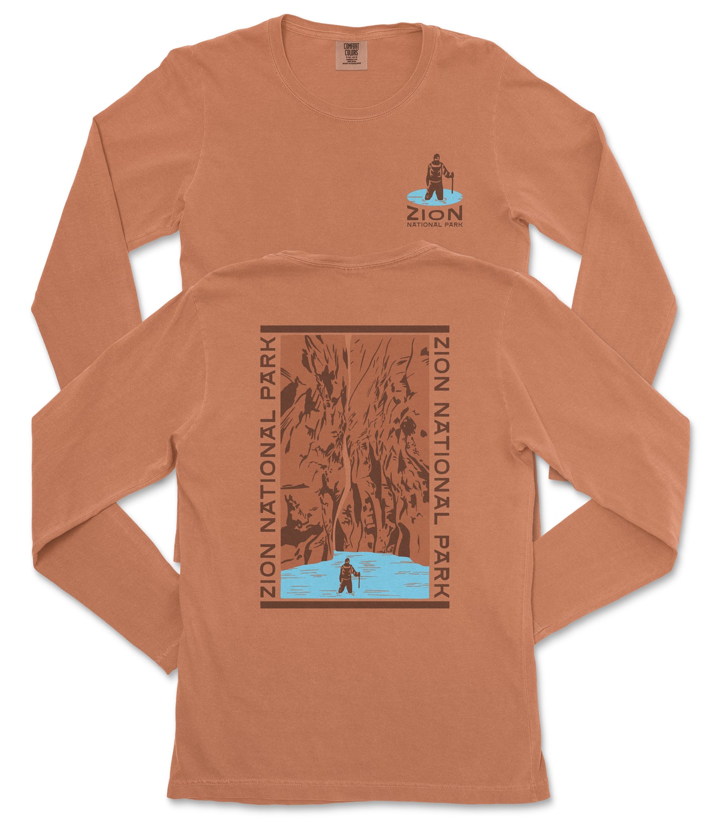 a long-sleeved orange t-shirt with a graphic design on the back, depicting a person standing in front of a waterfall.