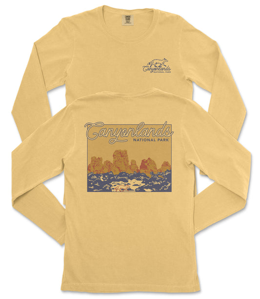 A yellow long-sleeved t-shirt with a graphic design depicting a scenic landscape, specifically the Canyonlands National Park.