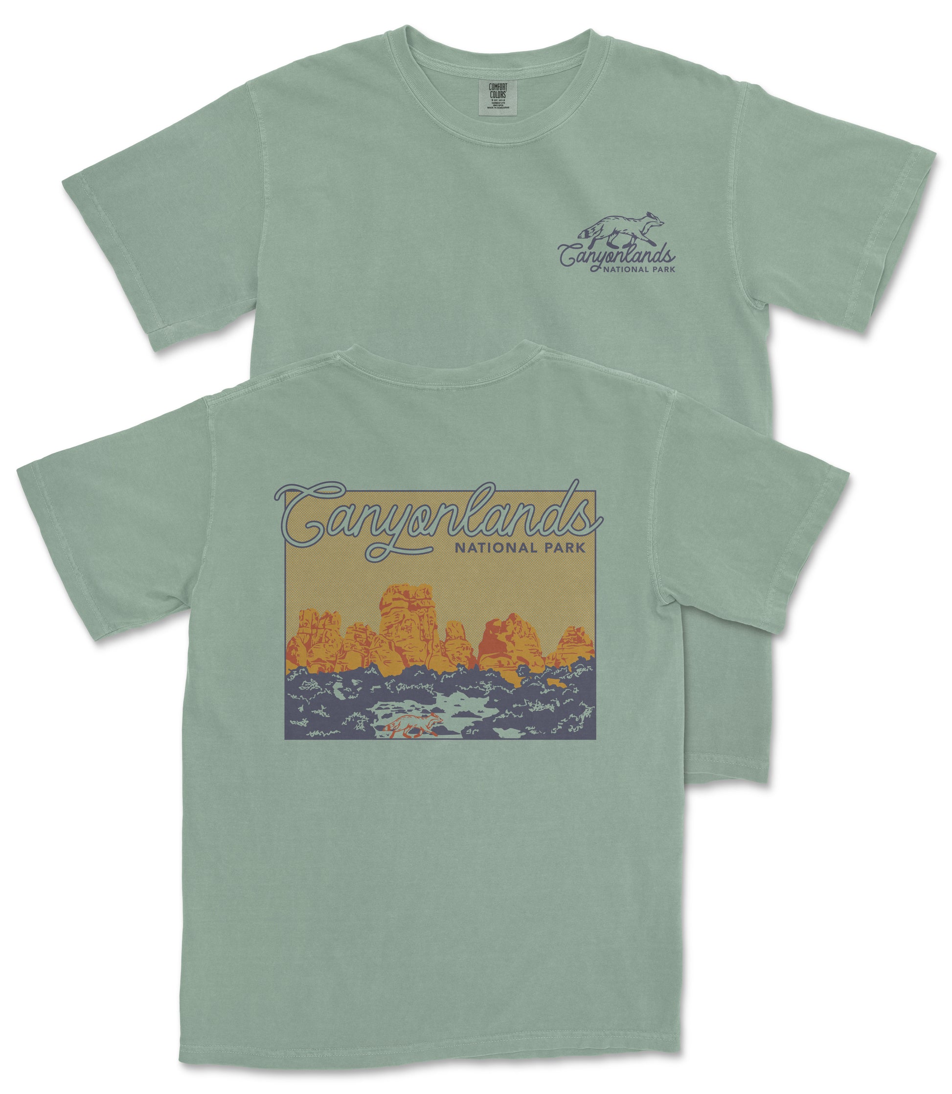 A green t-shirt with a graphic design depicting a scenic landscape with mountains and a river.