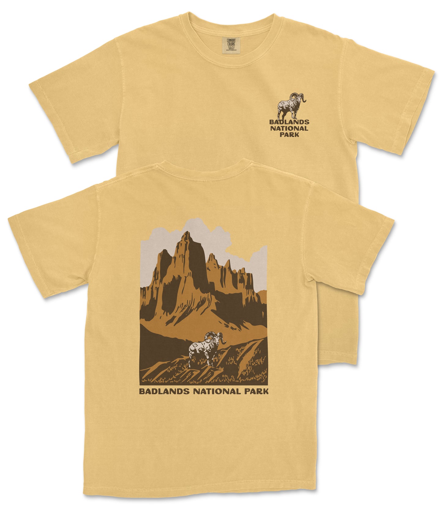 A yellow t-shirt with a graphic design depicting a mountain landscape and a goat, along with the text "Badlands National Park".