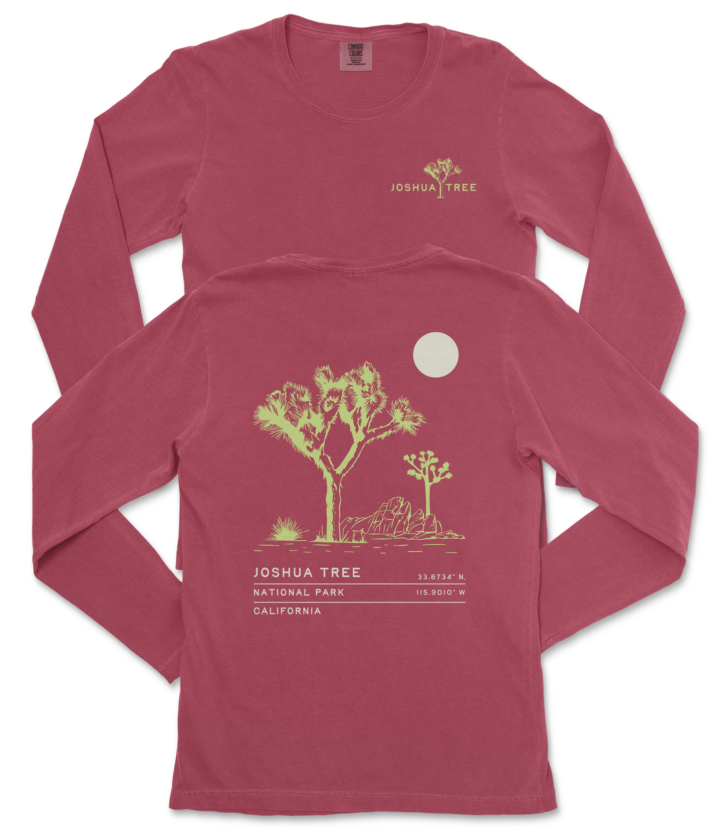 a red long-sleeved t-shirt with a graphic design depicting a desert landscape, including a tree and a moon. The text on the t-shirt reads "JOSUA TREE" and "33.8747° N 115.9013° W", indicating the location of Joshua Tree National Park in California.