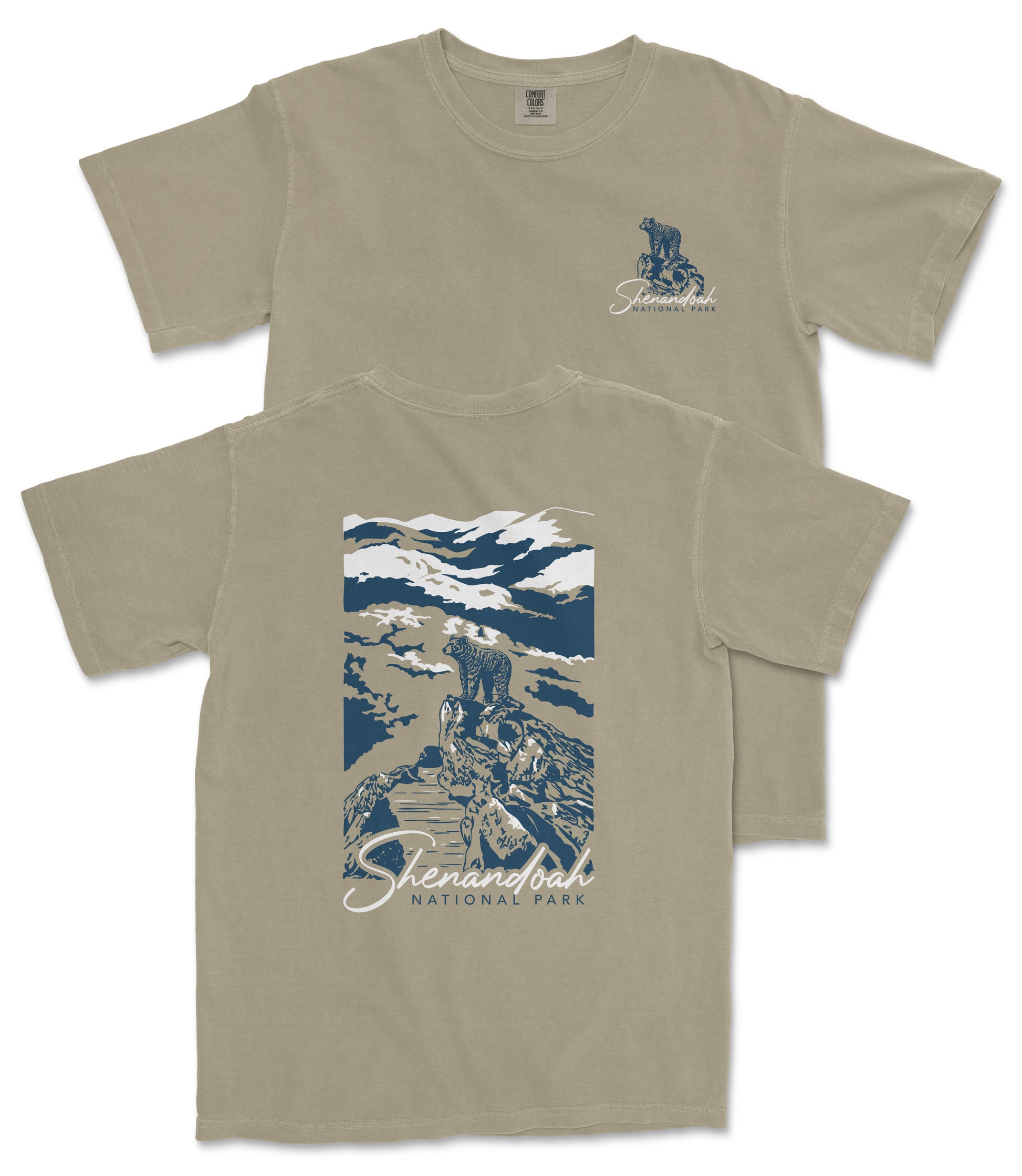 a tan t-shirt with a graphic design depicting a mountain landscape with a person standing on a rock.