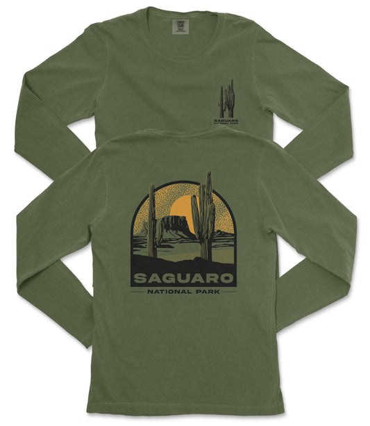 A green long-sleeved t-shirt with a graphic design depicting a desert landscape with a cactus and a sunset.