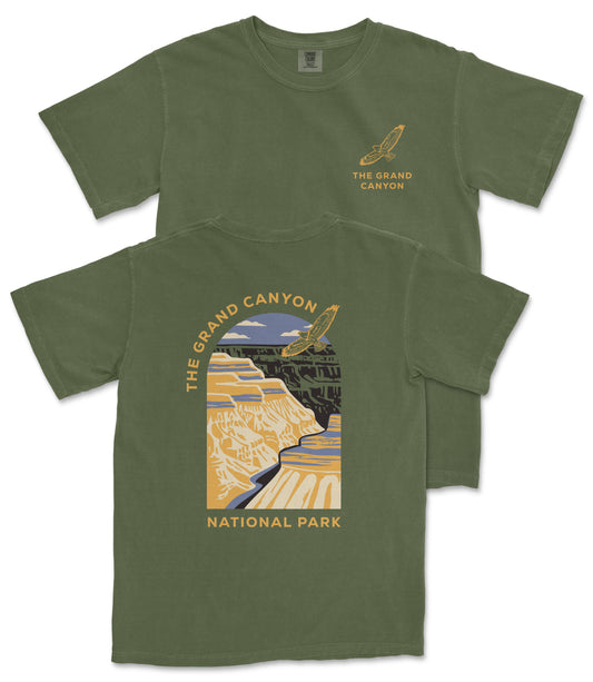 A green t-shirt with a graphic design depicting the Grand Canyon and the text "The Grand Canyon National Park" printed on it.