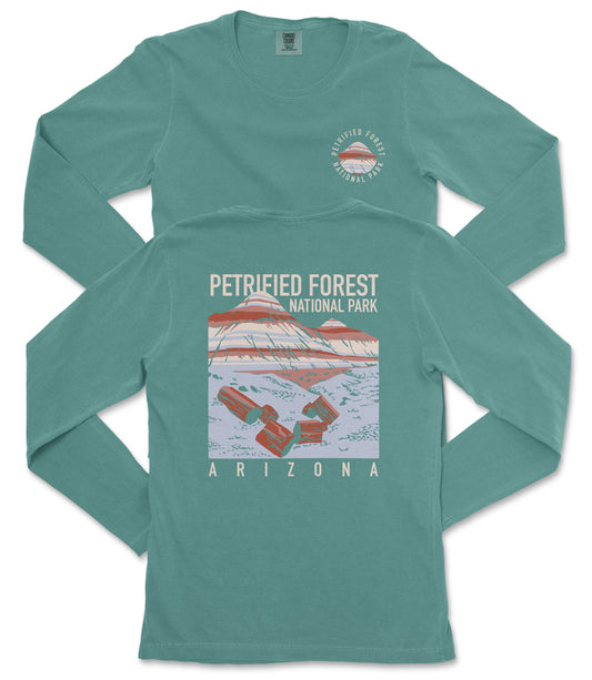 A long-sleeved green t-shirt with a graphic design depicting a mountain and the text "PETRIFIED FOREST NATIONAL PARK ARIZONA" printed on it.