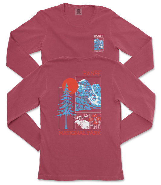 a red long-sleeved t-shirt with a graphic design depicting a mountain landscape, including a sun, pine trees, and a moose.