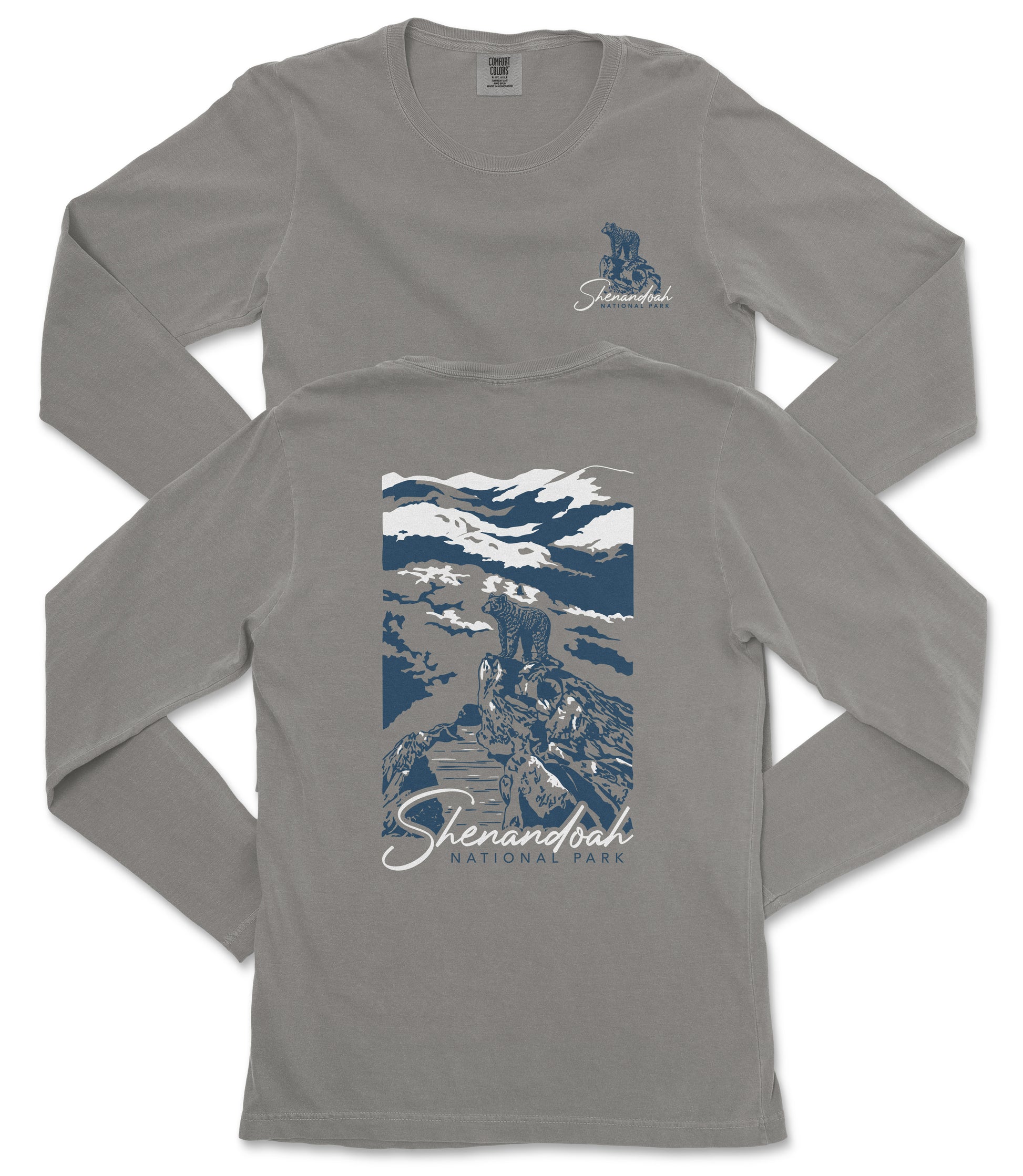 a gray long-sleeved t-shirt with a graphic design on the back. The design depicts a mountain landscape with a person standing on a rock. The text "Shenandoah National Park" is printed below the graphic.