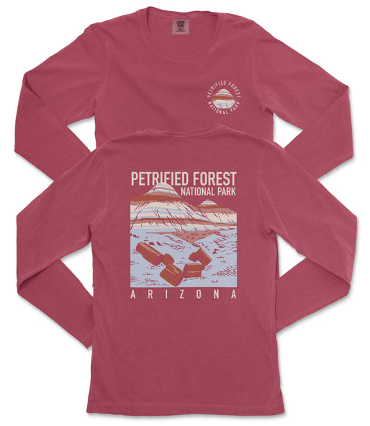 A red long-sleeved t-shirt with a graphic design depicting a mountain range and the text "PETRIFIED FOREST NATIONAL PARK ARIZONA" printed on it.