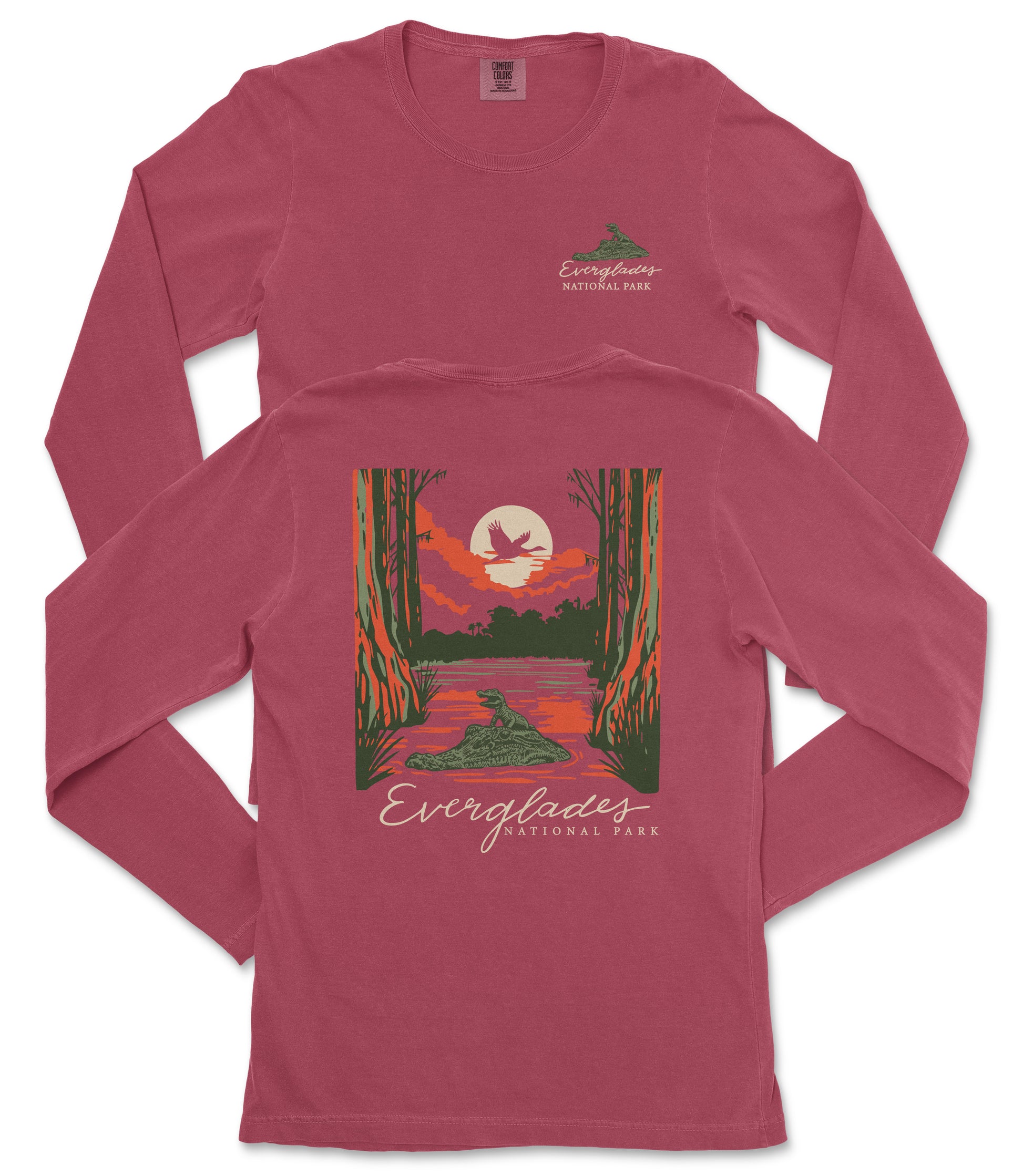A red long-sleeved t-shirt with a graphic design depicting a sunset over a lake, surrounded by trees and wildlife.