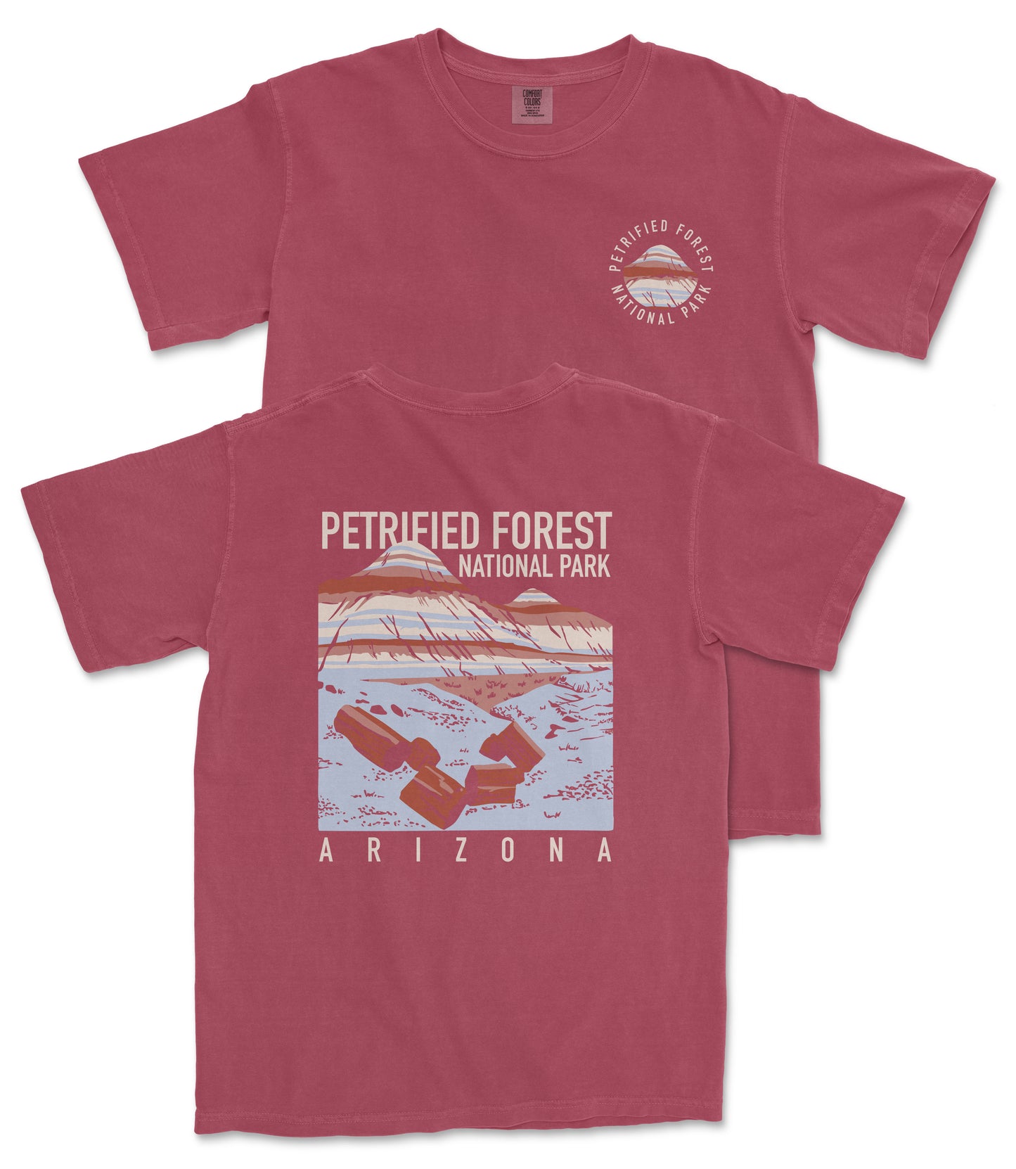 A red t-shirt with a graphic design depicting a landscape with mountains and a lake, along with text that reads "Petrified Forest National Park Arizona".