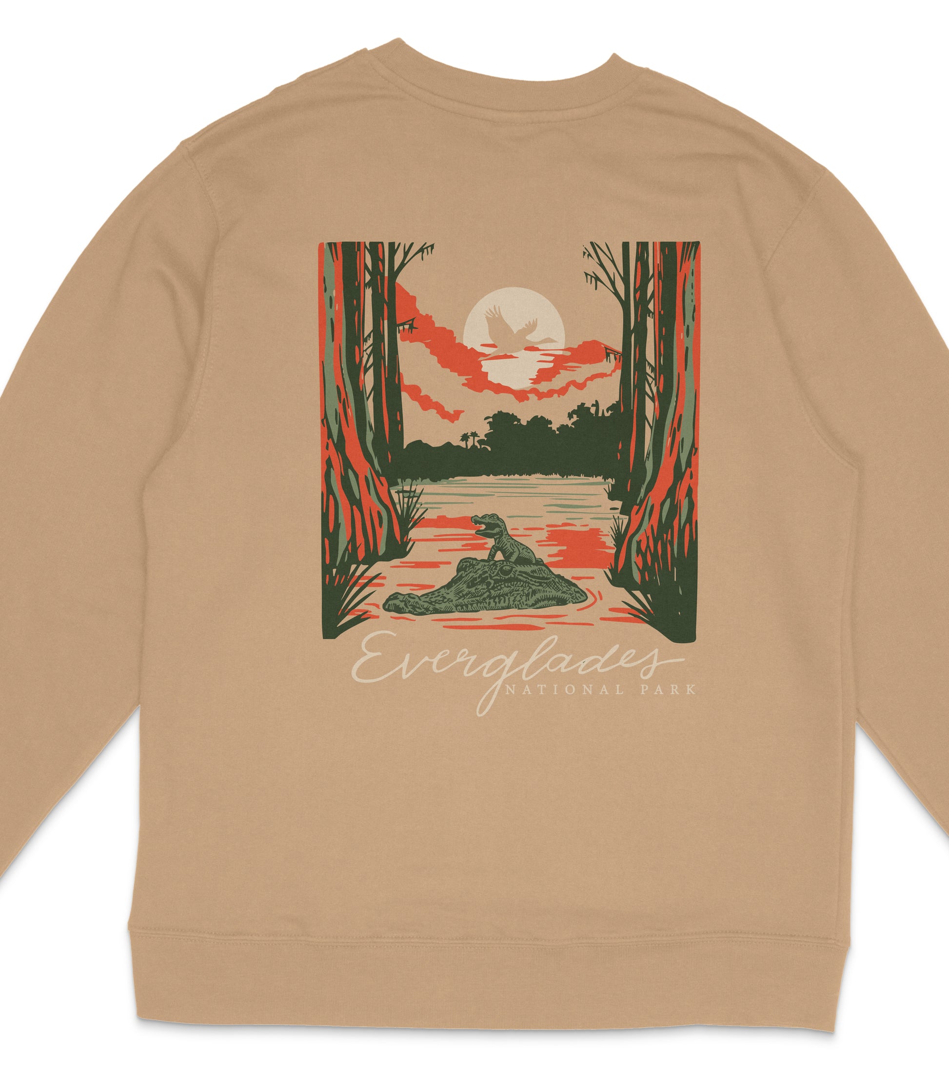 A tan sweatshirt with a graphic design depicting a sunset over a body of water, surrounded by trees and wildlife.