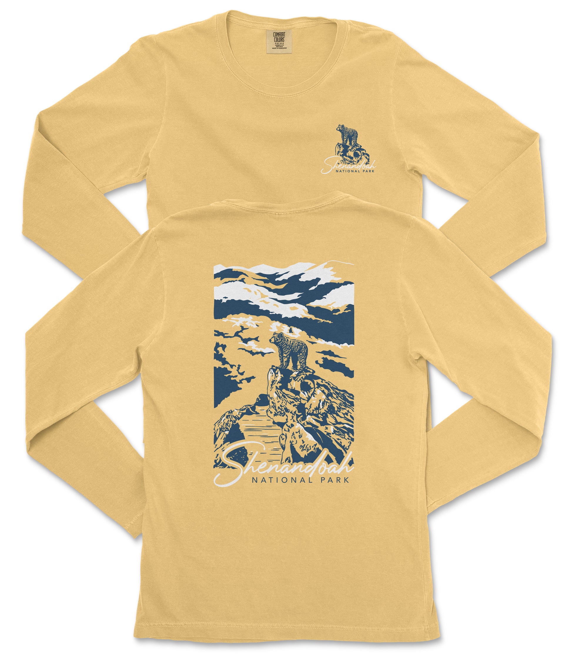 a yellow long-sleeved t-shirt with a graphic design depicting a mountain landscape and a bear.