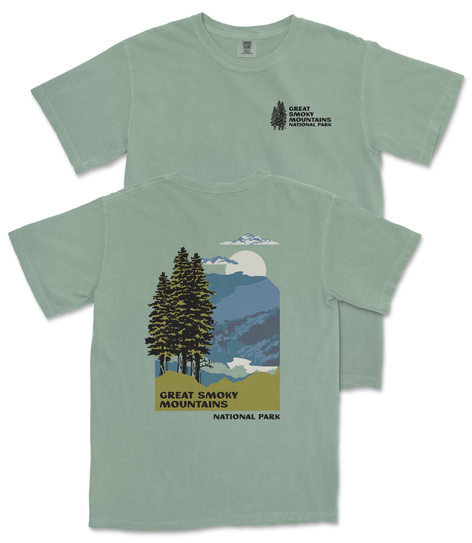 A green t-shirt with a graphic design depicting a mountain landscape with pine trees, a full moon, and clouds. The text on the t-shirt reads "GREAT SMOKY MOUNTAINS NATIONAL PARK".