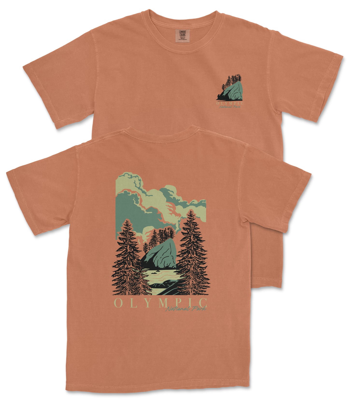 a t-shirt with a graphic design depicting a scenic landscape with pine trees, mountains, and a body of water.