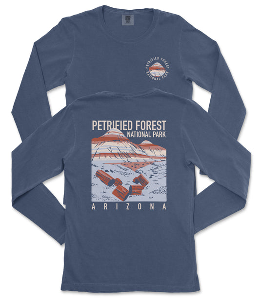 a long-sleeved blue t-shirt with a graphic design depicting a mountain range and the text "Petrified Forest National Park Arizona" printed on it.