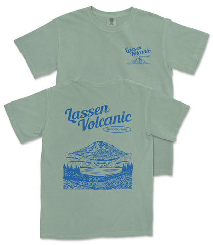 A green t-shirt with a graphic design depicting a mountain landscape and the text "Lassen Volcanic National Park" printed on it.