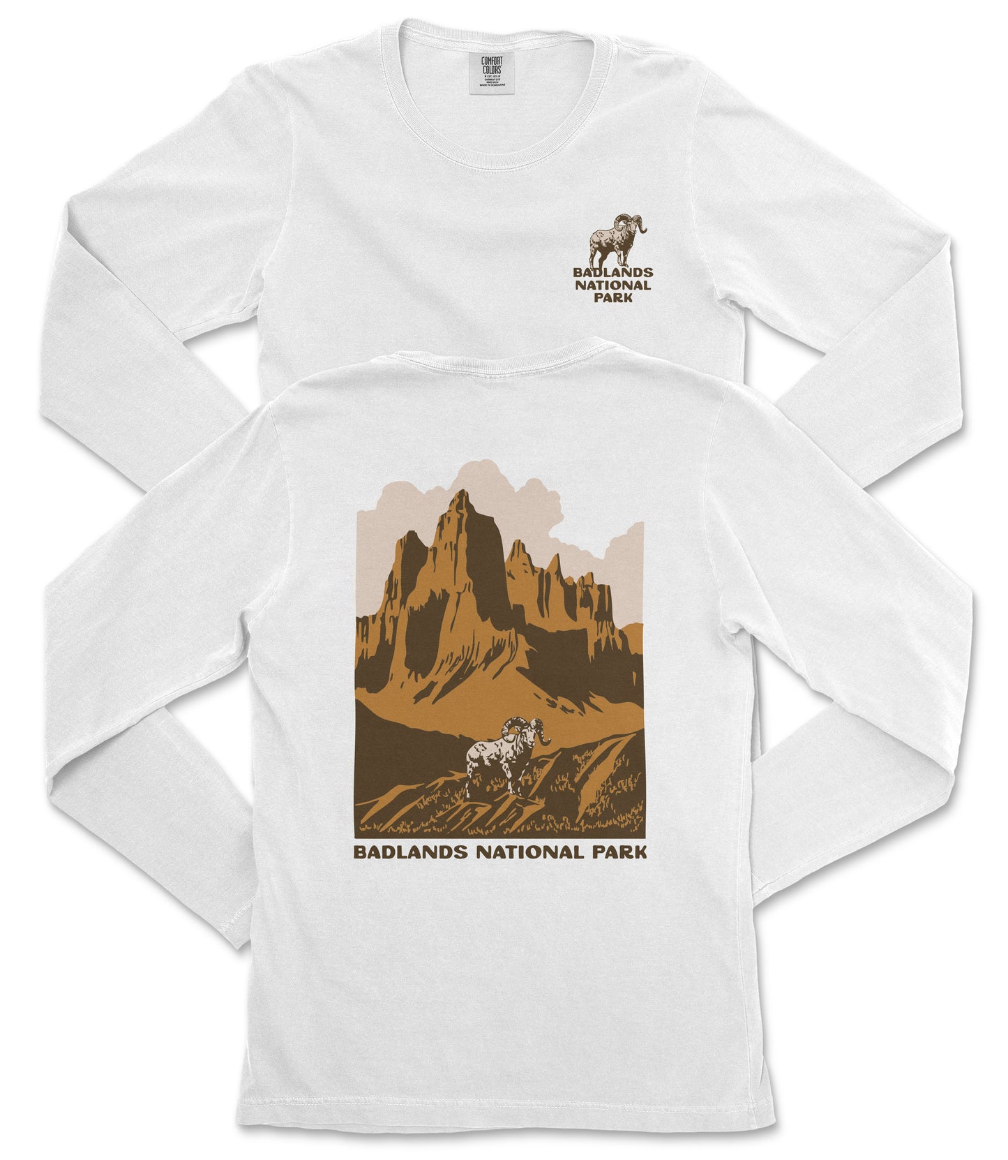 a white long-sleeved t-shirt with a graphic design depicting a mountain landscape and a goat. The text "BADLANDS NATIONAL PARK" is printed below the mountain and goat illustration.
