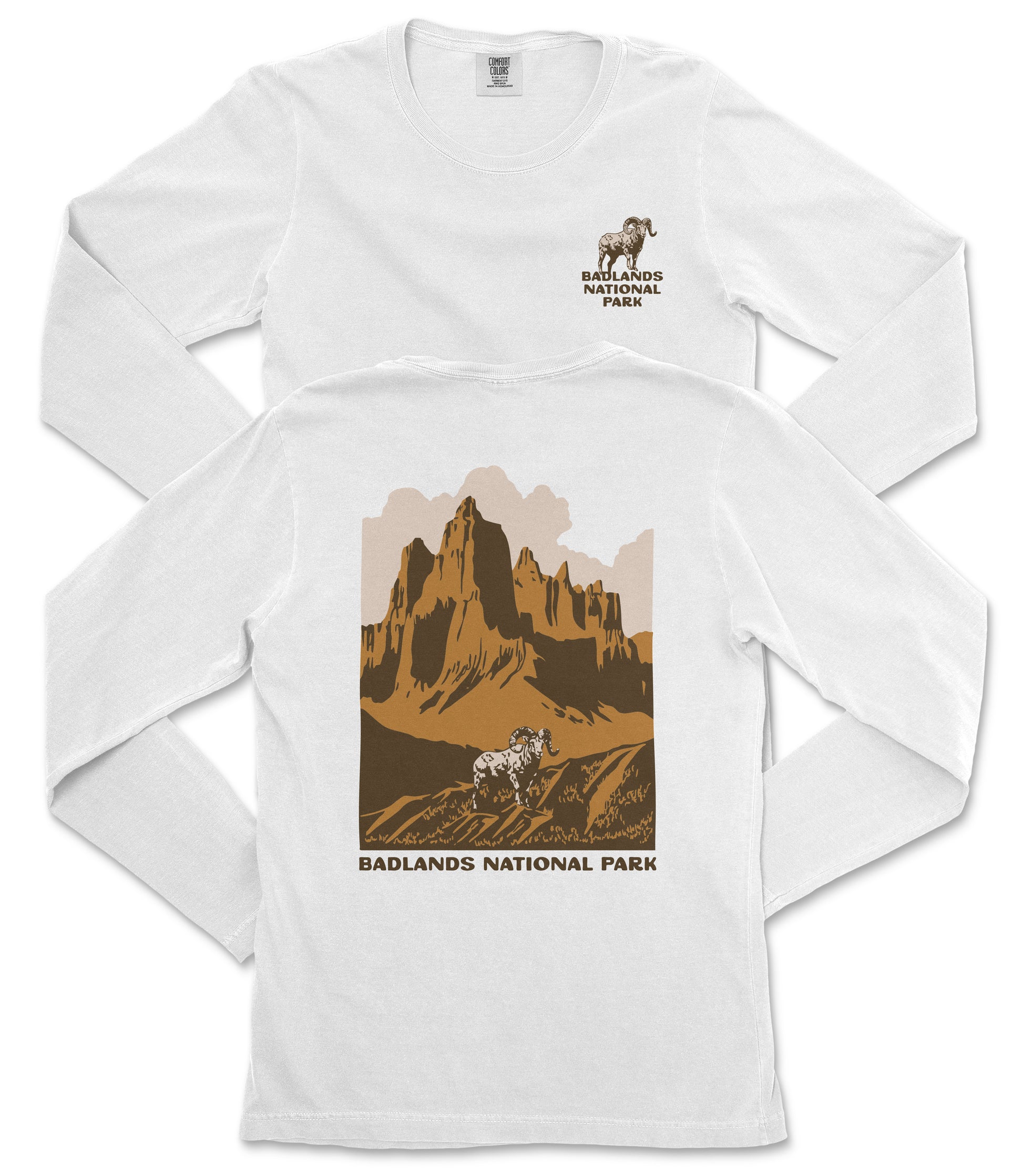 a white long-sleeved t-shirt with a graphic design depicting a mountain landscape and a goat. The text "BADLANDS NATIONAL PARK" is printed below the mountain and goat illustration.