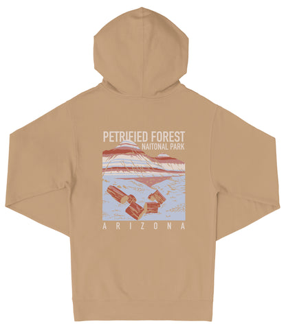 A beige hooded sweatshirt with a graphic design depicting a scenic landscape, including a mountain range and a body of water. The text on the back of the sweatshirt reads "PETRIFIED FOREST NATIONAL PARK ARIZONA".