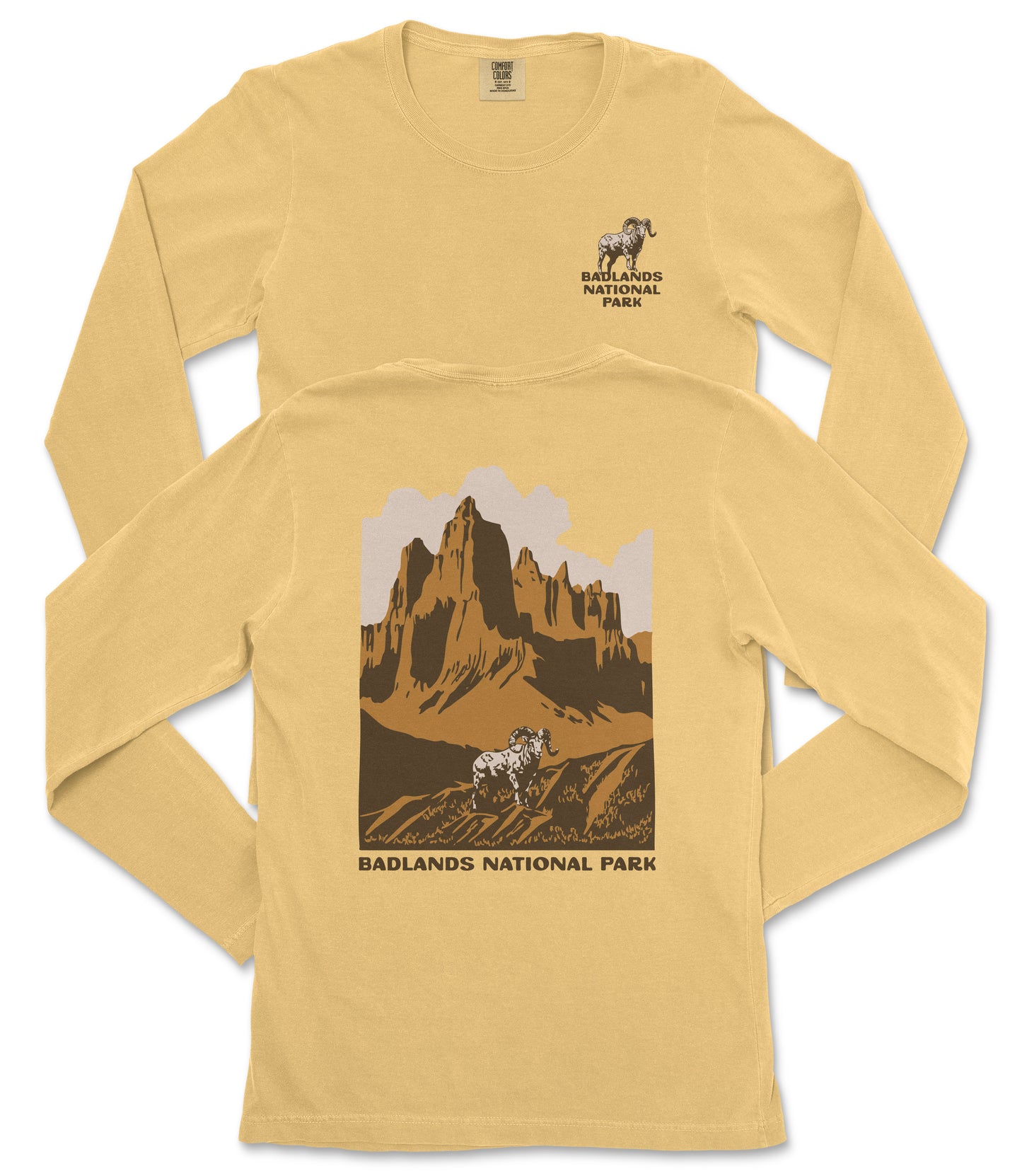 a yellow long-sleeved t-shirt with a graphic design depicting a mountain landscape and a goat. The text "BADLANDS NATIONAL PARK" is printed below the mountain and goat illustration.