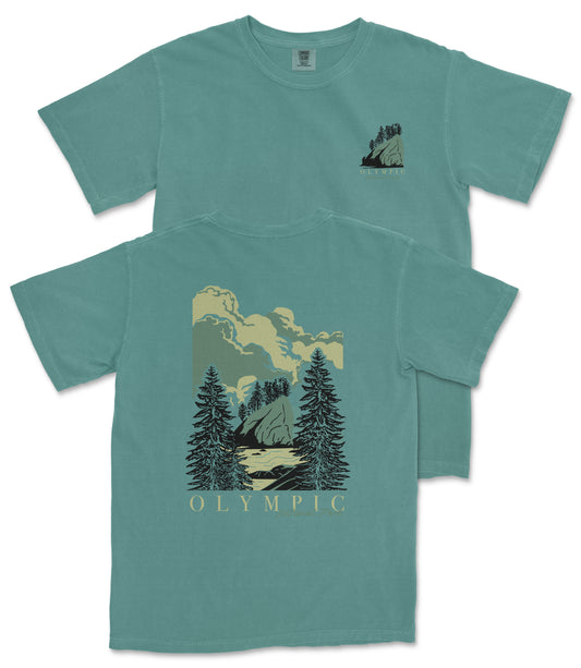 A teal-colored t-shirt with a graphic design depicting a mountain landscape with pine trees and clouds.