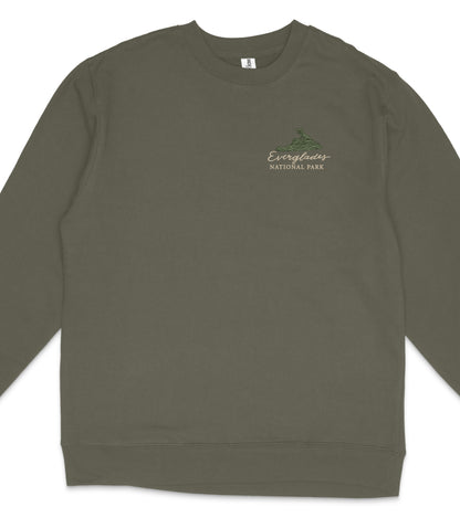 A dark green long-sleeved shirt with a small logo on the left side.