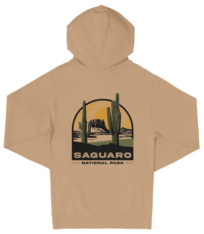 A beige hooded sweatshirt with a graphic design depicting a desert landscape with two cacti and the text "Saguaro National Park" printed on the back.