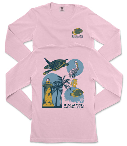 a pink long-sleeved shirt with a graphic design depicting various marine life and landmarks, including a lighthouse, a turtle, a bird, and a palm tree.