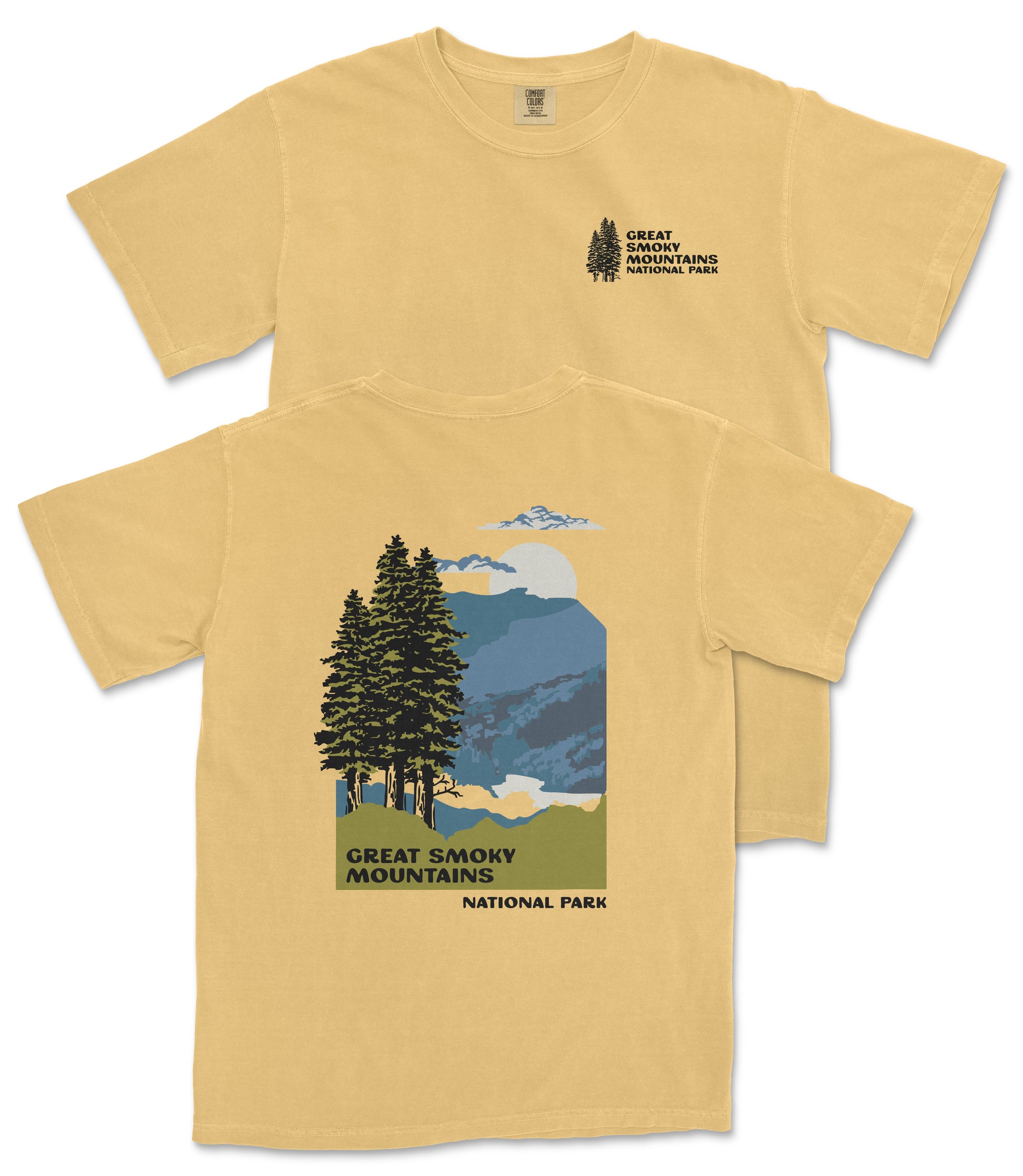 A yellow t-shirt with a graphic design depicting a scenic mountain landscape with pine trees, mountains, and a cloudy sky.