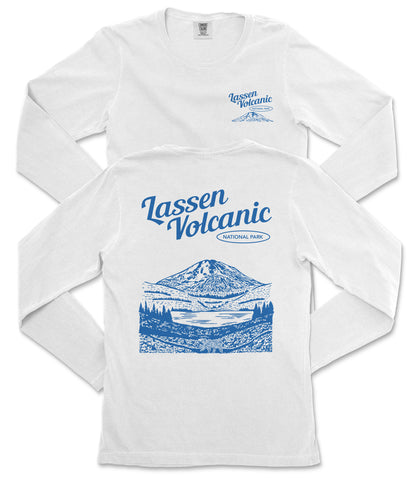 A white long-sleeved t-shirt with a graphic design depicting a mountain landscape and a lake, along with text that reads "Lassen Volcanic National Park".
