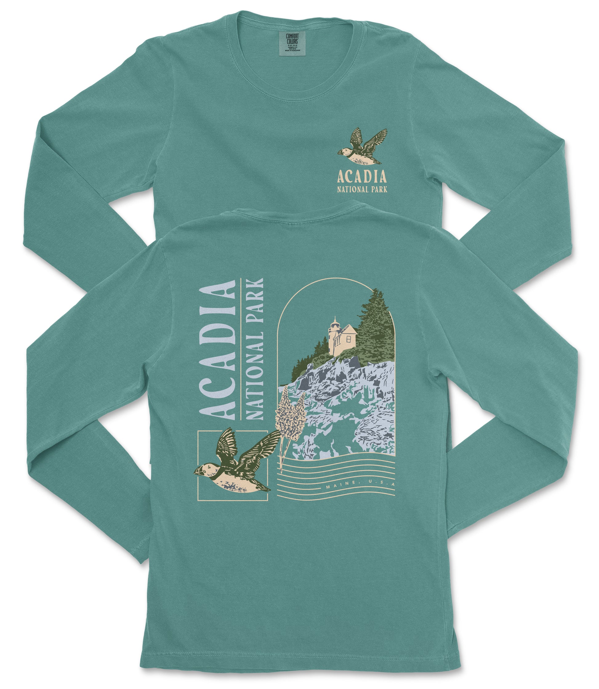 A long-sleeved green t-shirt with a graphic design depicting a bird, a castle, and a river, along with text that says "ACADIA NATIONAL PARK".