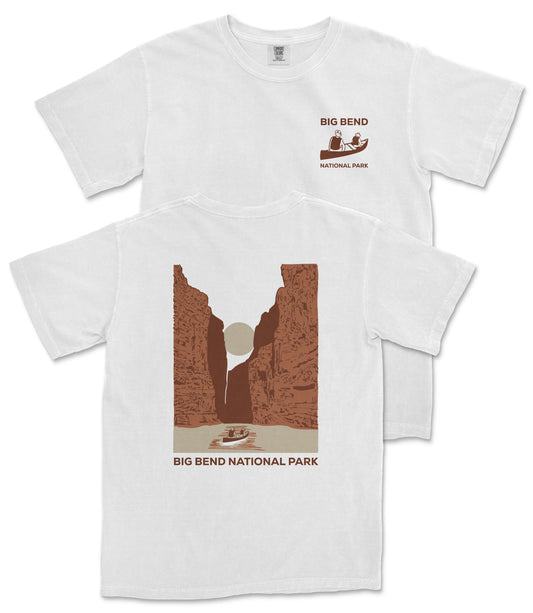 A white t-shirt with a graphic design depicting a canyon landscape and a boat on a river, along with the text "BIG BEND NATIONAL PARK".