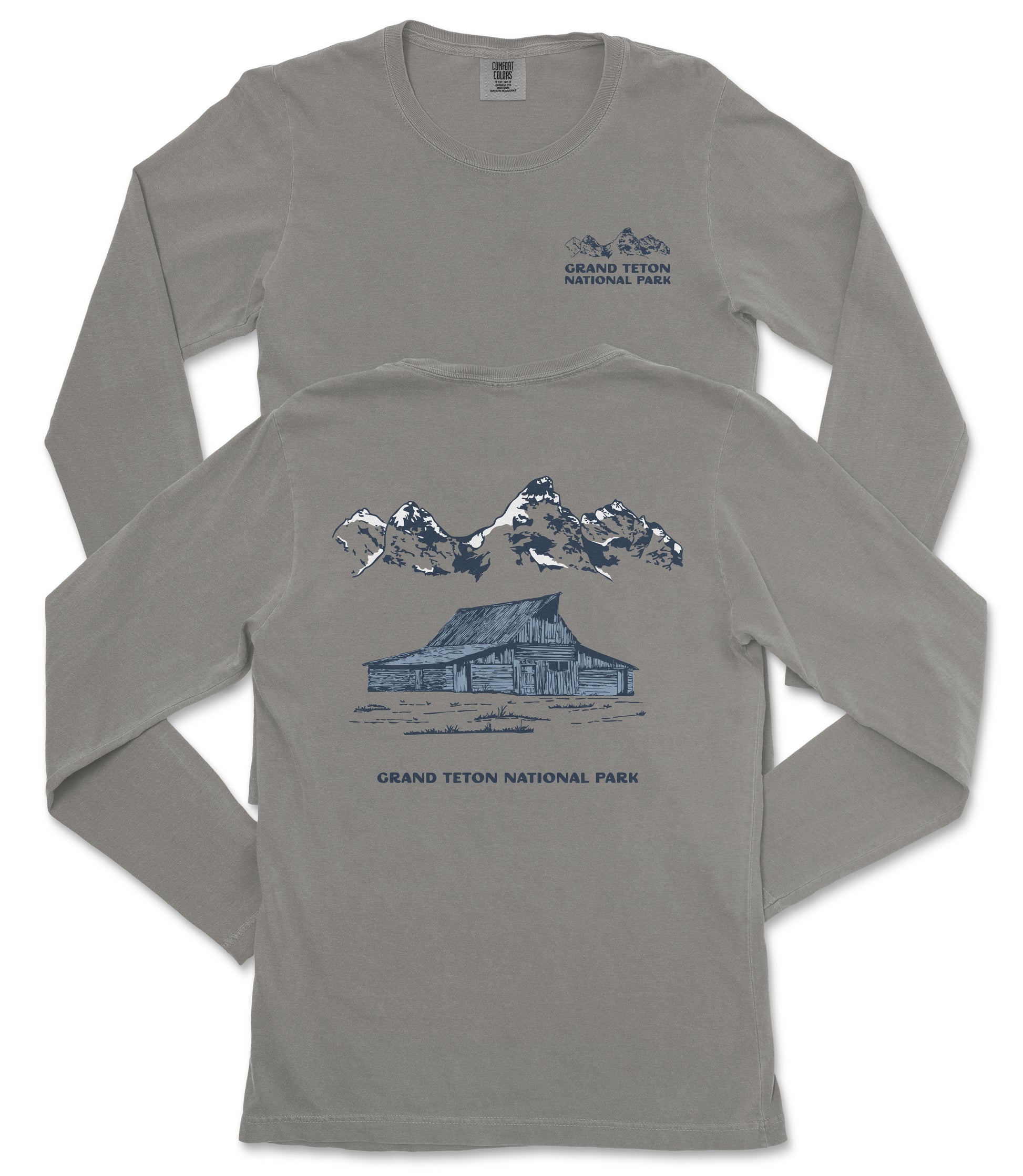 a gray long-sleeved t-shirt with a graphic design depicting a cabin and mountains, along with the text "Grand Teton National Park".