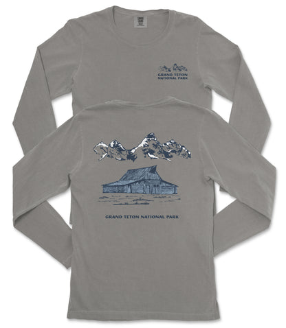 a gray long-sleeved t-shirt with a graphic design depicting a cabin and mountains, along with the text "Grand Teton National Park".