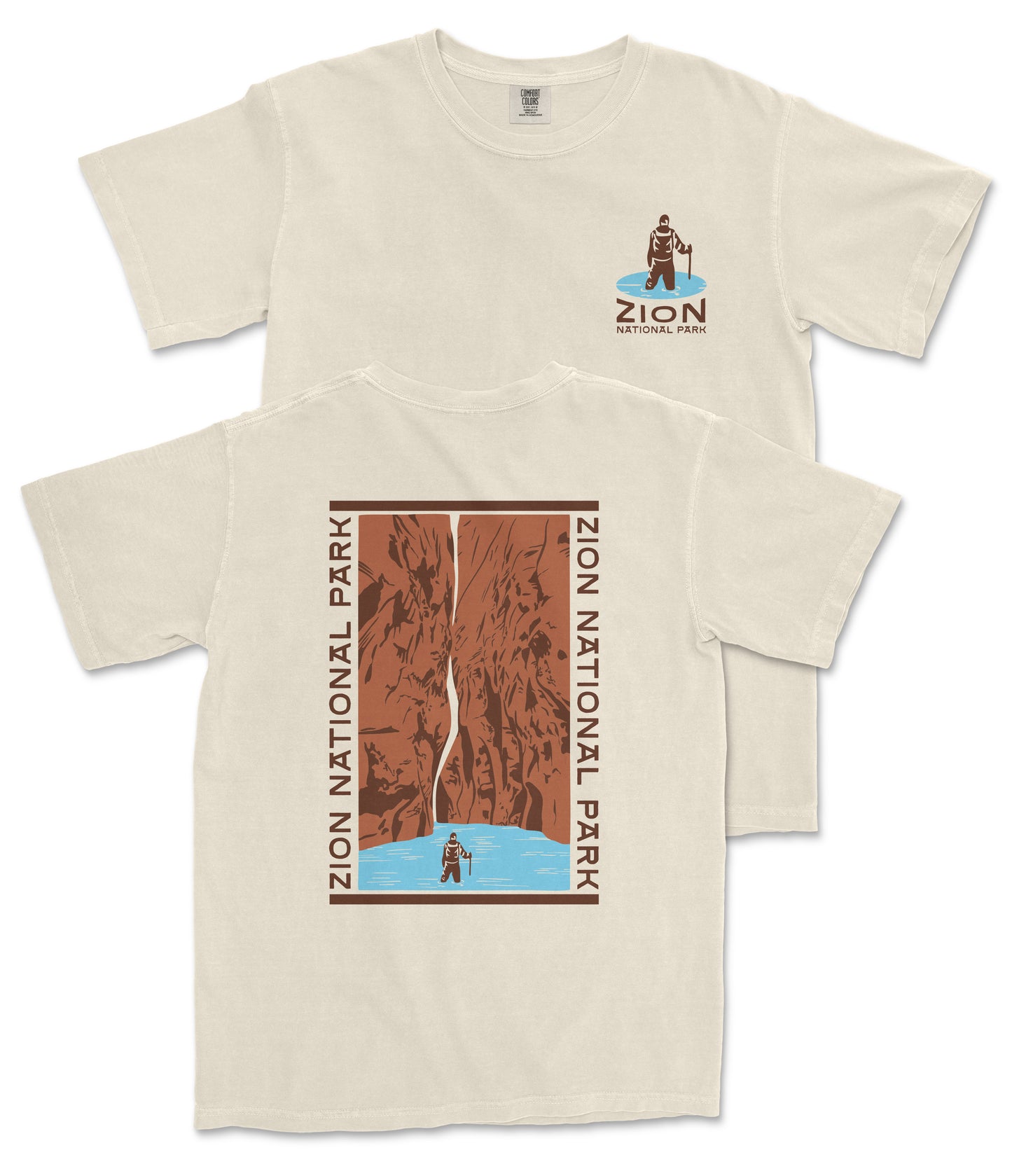 a beige t-shirt with a graphic design depicting a person standing on a cliff overlooking a waterfall. The design includes the text "ZION NATIONAL PARK" and "ZION" along with a small illustration of a person standing on the cliff.