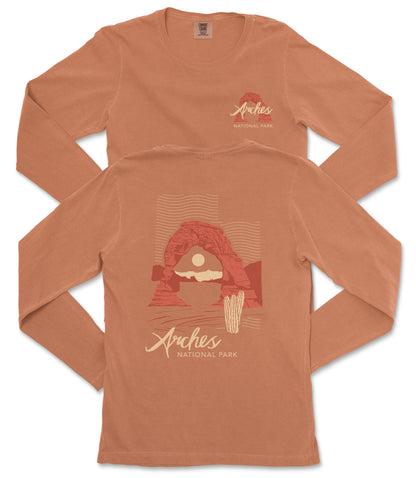 two long-sleeved t-shirts with a graphic design featuring a desert landscape with a rock formation and a cactus. The text on the t-shirts reads "Arches National Park".
