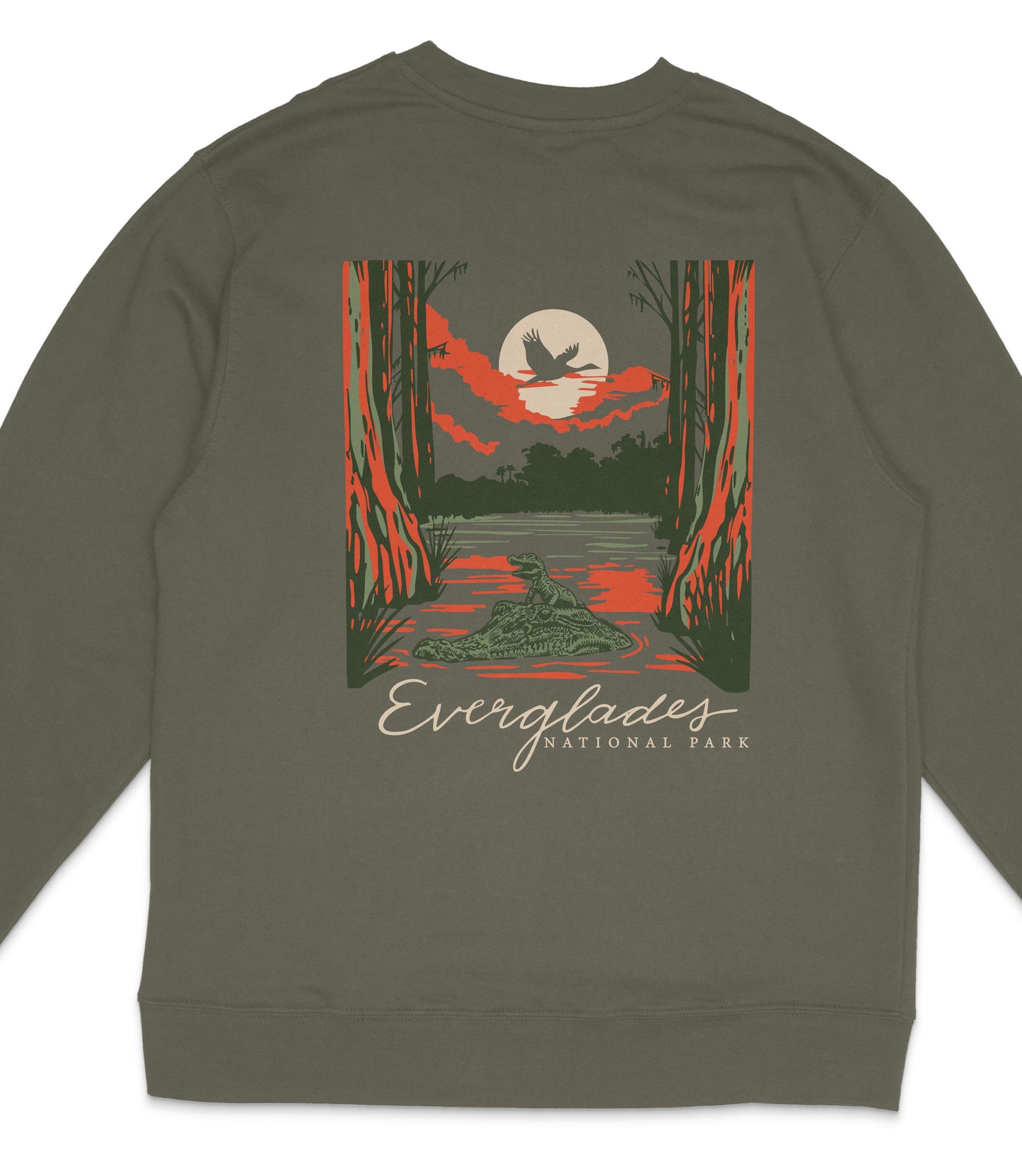 A graphic t-shirt design featuring a nighttime scene with a bird flying over a lake, surrounded by trees and a full moon.