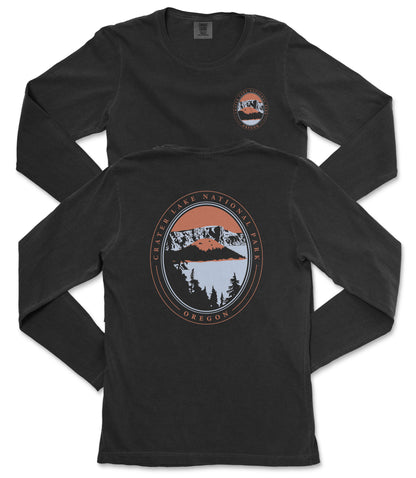 a black long-sleeve t-shirt with a graphic design on the back. The design includes a circular emblem with a mountain range and a lake, surrounded by text that reads "CASTER LAKE NATIONAL PARK, OREGON".