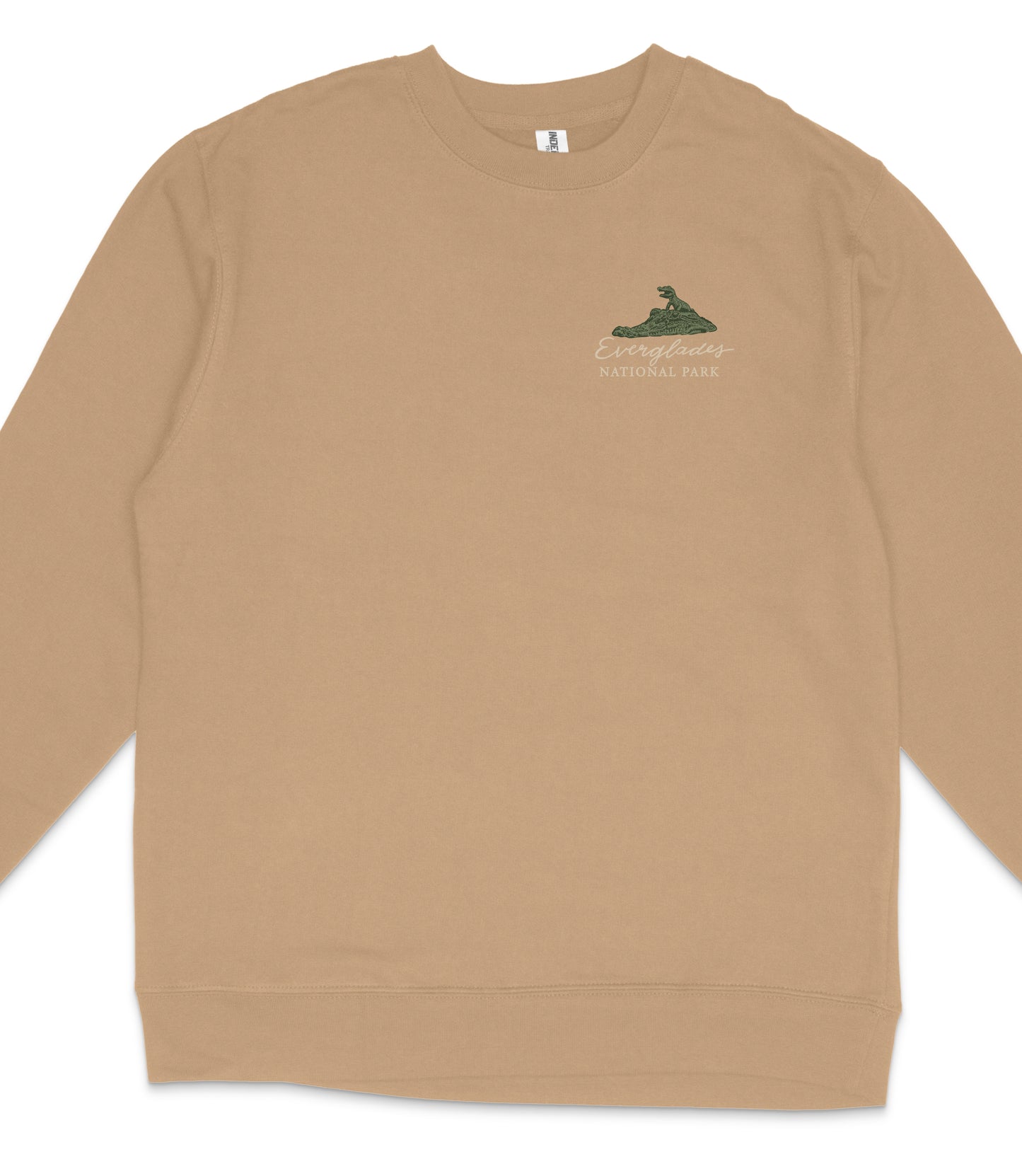 A tan long-sleeved shirt with a small graphic of a green mountain on the left side.