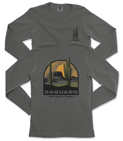 a gray long-sleeved t-shirt with a graphic design depicting a desert landscape with cacti and mountains, along with the text "Saguaro National Park".