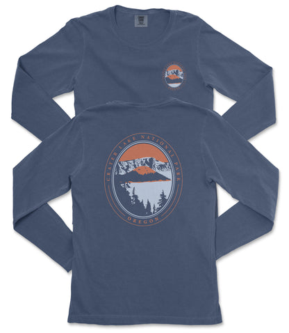 a pair of navy blue long-sleeved t-shirts with a graphic design on the back. The design features a mountain landscape with a lake and trees, along with the text "CASTER LAKE NATIONAL PARK OREGON" printed around the design.