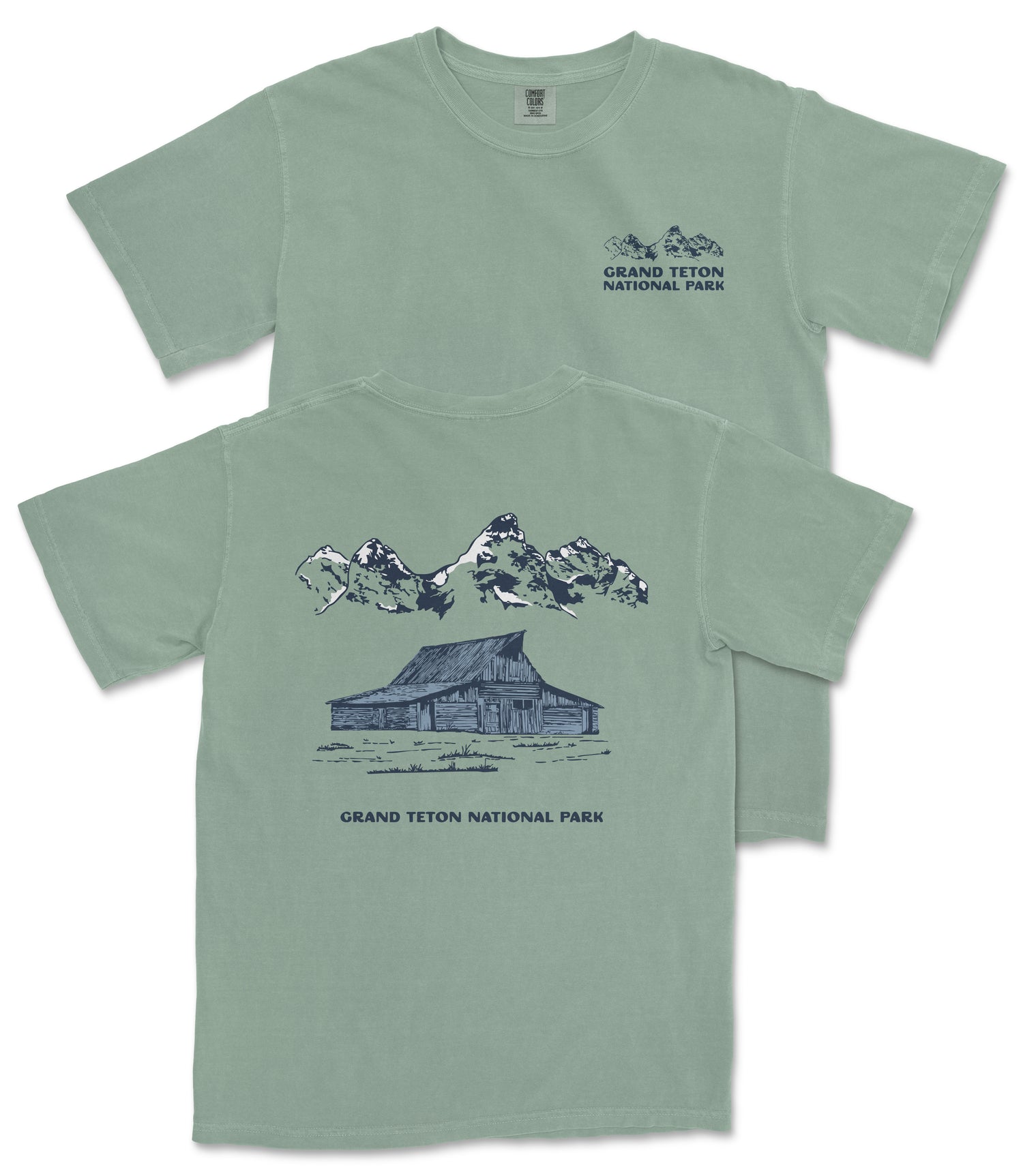 A green t-shirt with a graphic design depicting a cabin and mountains, along with the text "Grand Teton National Park".