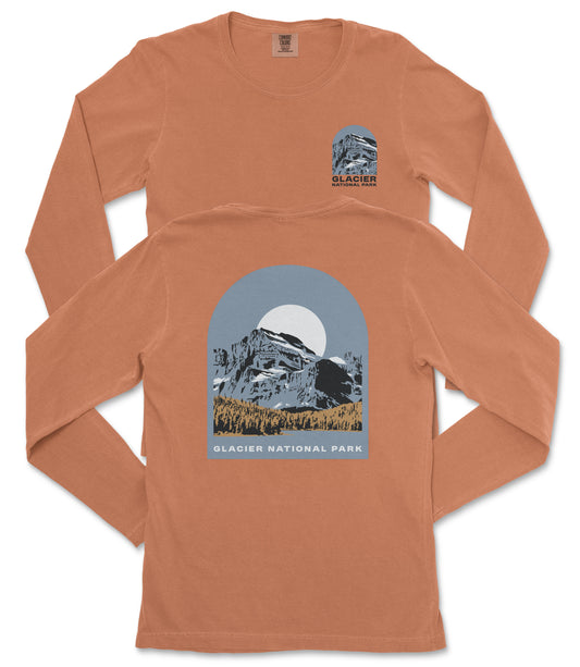 a long-sleeved orange t-shirt with a graphic design depicting a mountain landscape and the text "Glacier National Park" printed on it.