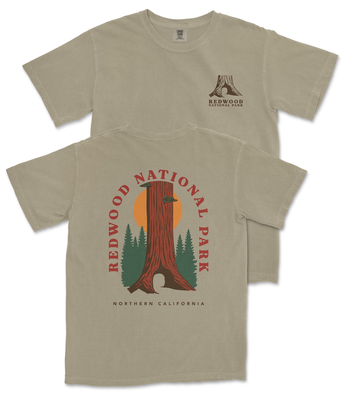 a beige t-shirt with a graphic design depicting a tall tree with a sun-like symbol in the center, surrounded by pine trees. The text on the t-shirt reads "REDWOOD NATIONAL PARK NORTHERN CALIFORNIA".
