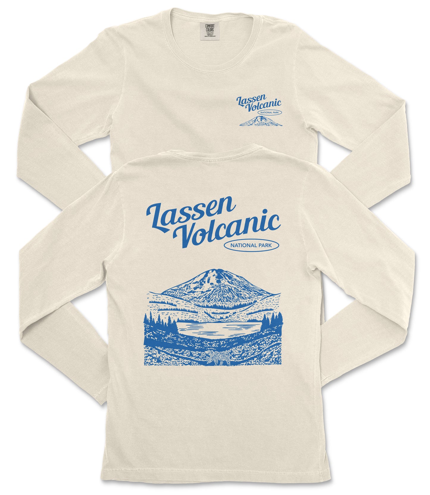 a cream-colored long-sleeved t-shirt with a graphic design depicting a mountain landscape and a lake. The design includes the text "Lassen Volcanic National Park" printed on the back of the shirt.