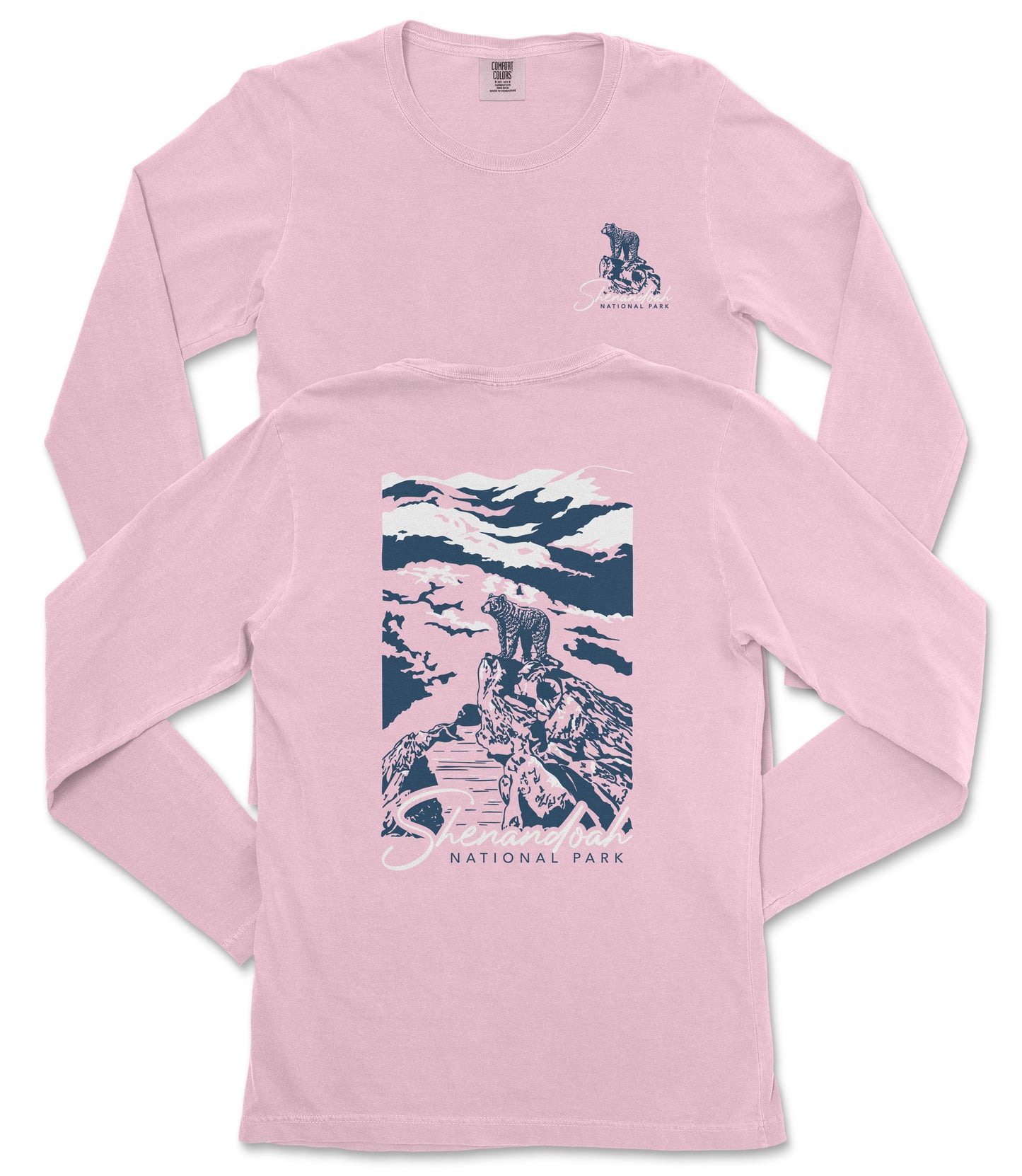 A pink long-sleeved t-shirt with a graphic design depicting a person standing on a rock, overlooking a scenic landscape with mountains and a body of water.