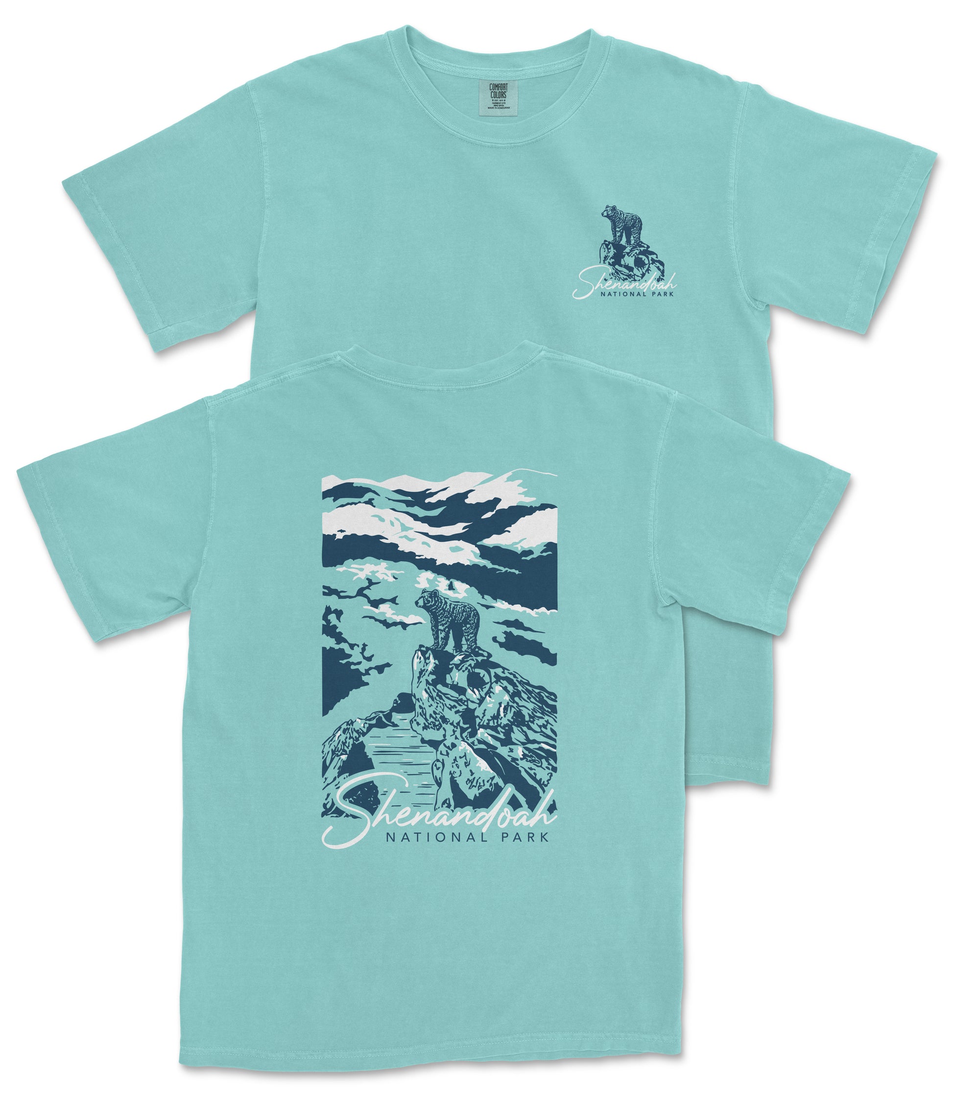 A turquoise t-shirt with a graphic design depicting a mountain landscape and a person standing on a rock.