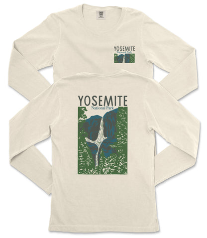 A white long-sleeved t-shirt with a graphic design depicting a waterfall and mountains, along with the text "Yosemite National Park" printed on it.