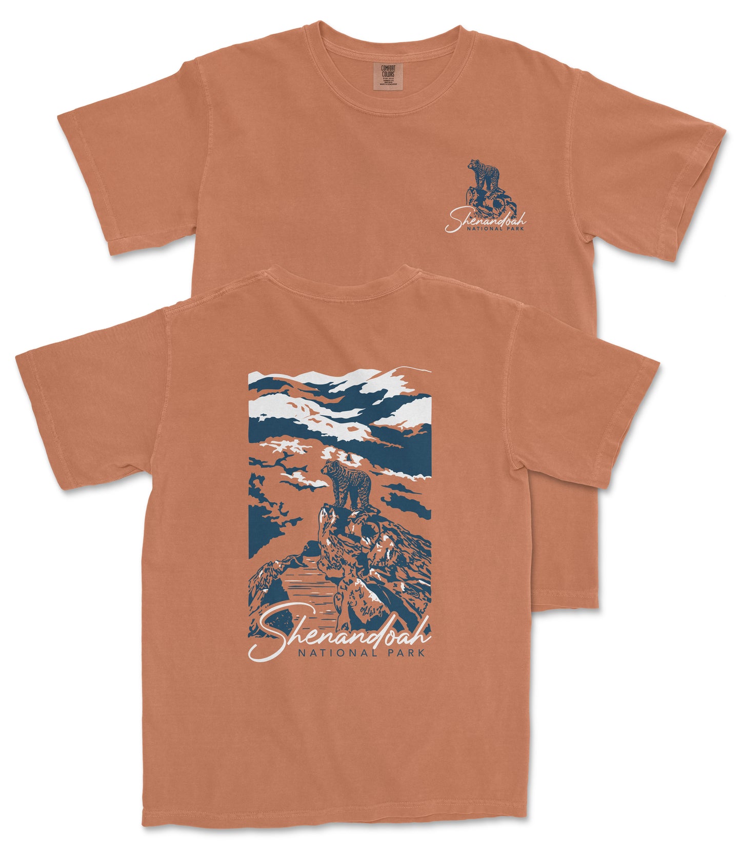 a t-shirt with a graphic design depicting a mountain landscape with a person standing on a rock. The text on the t-shirt reads "Shenandoah National Park".