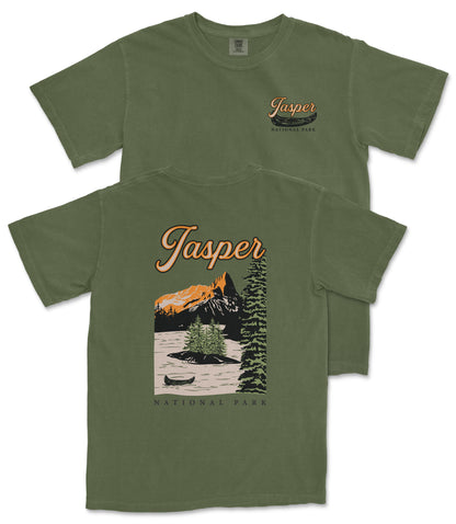 A green t-shirt with a graphic design depicting a mountain landscape, a canoe, and the text "Jasper National Park" printed on it.